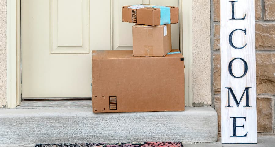 Packages on the doorstep of a home with a welcome sign in Lake Havasu